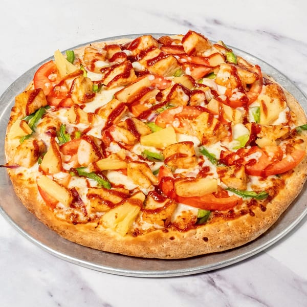 Ristorante da Maria's BBQ chicken pizza with pineapple, tomatoes, and green peppers on a metal pan.